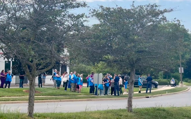 Police officers speak to Walmart employees outside a Walmart store, where a stabbing incident occurred, in Traverse City, Michigan, U.S. July 26, 2025, in this screen grab taken from a social media video.