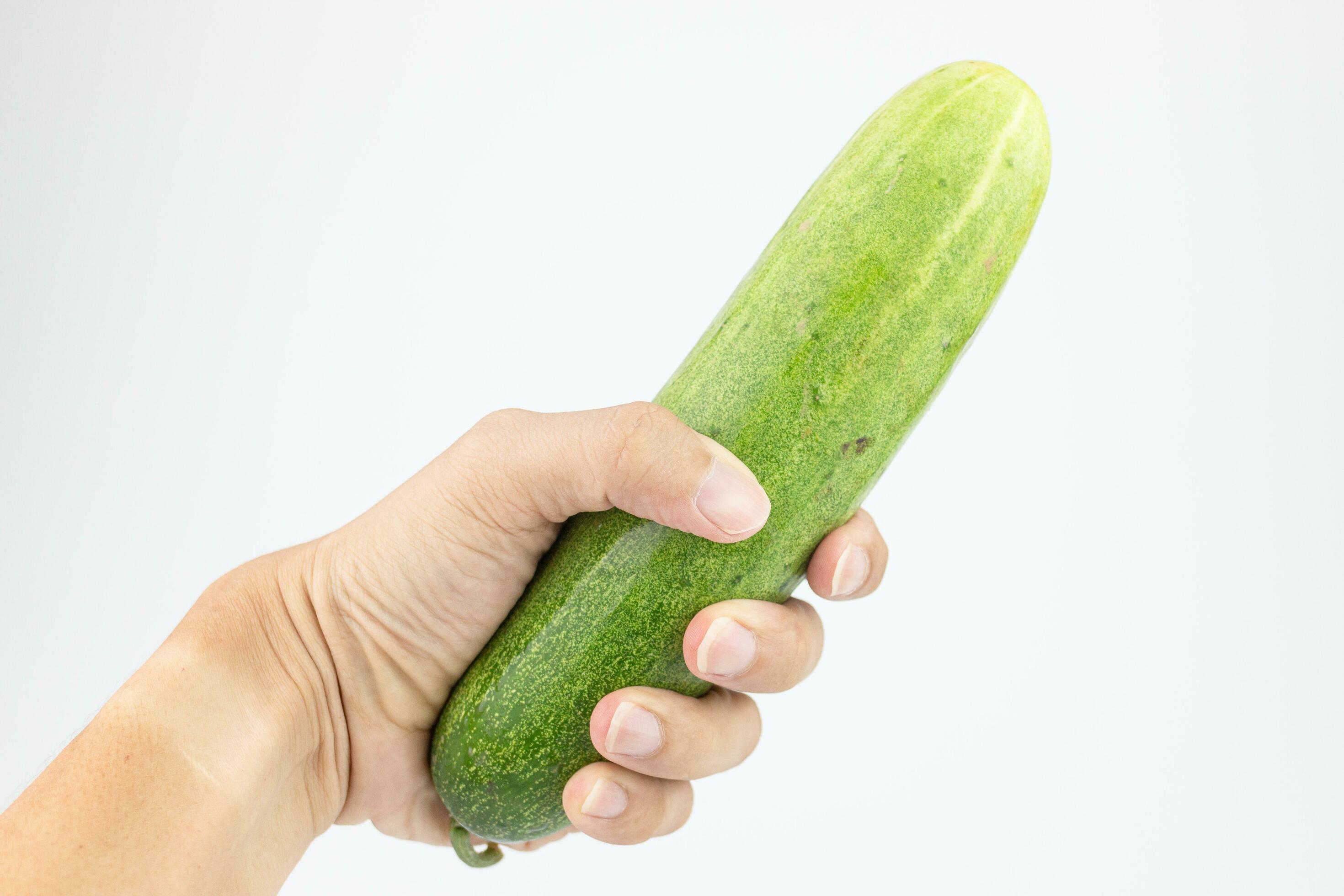 Cucumber in hand isolated on white background with clipping path. 26513079  Stock Photo at Vecteezy